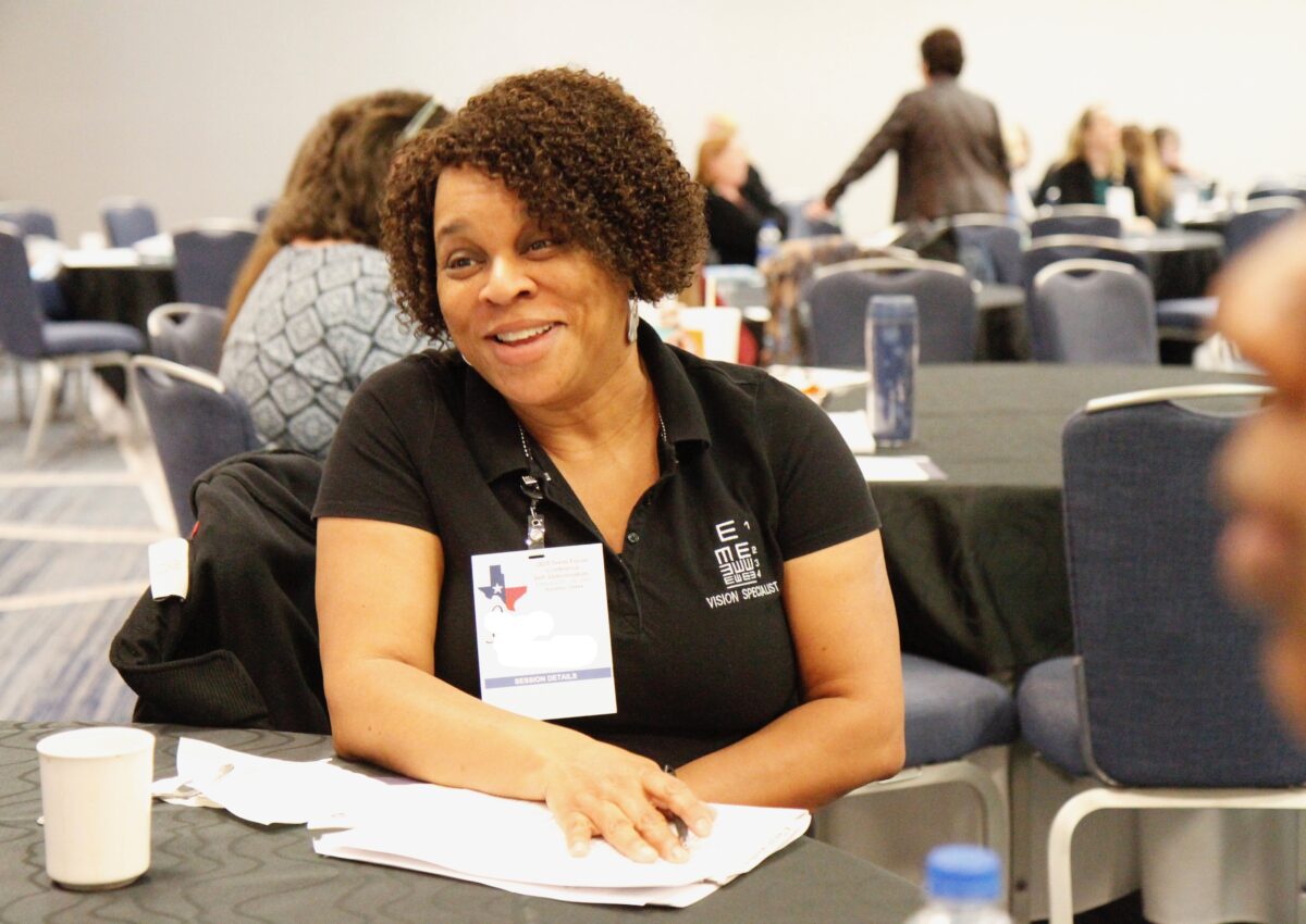 An adult wearing a shirt embroidered with 