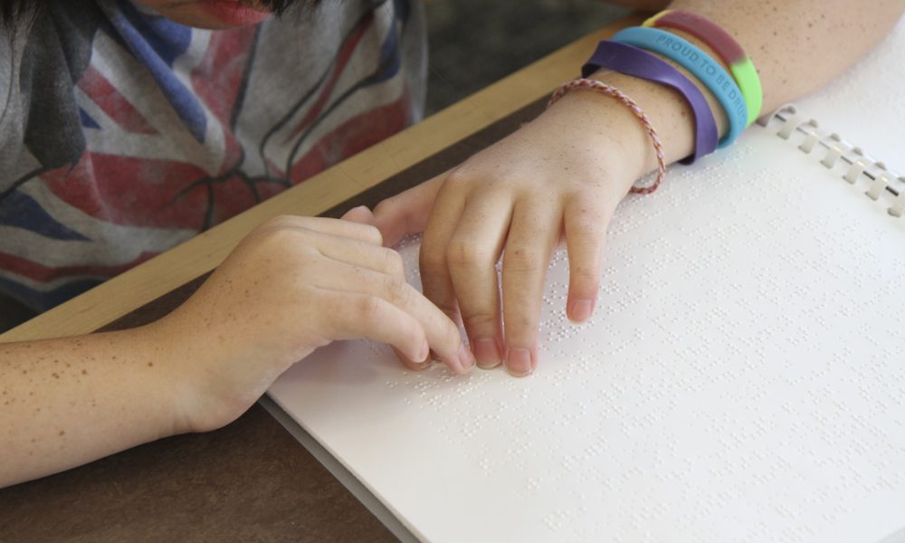 A pair of hands using braille to read