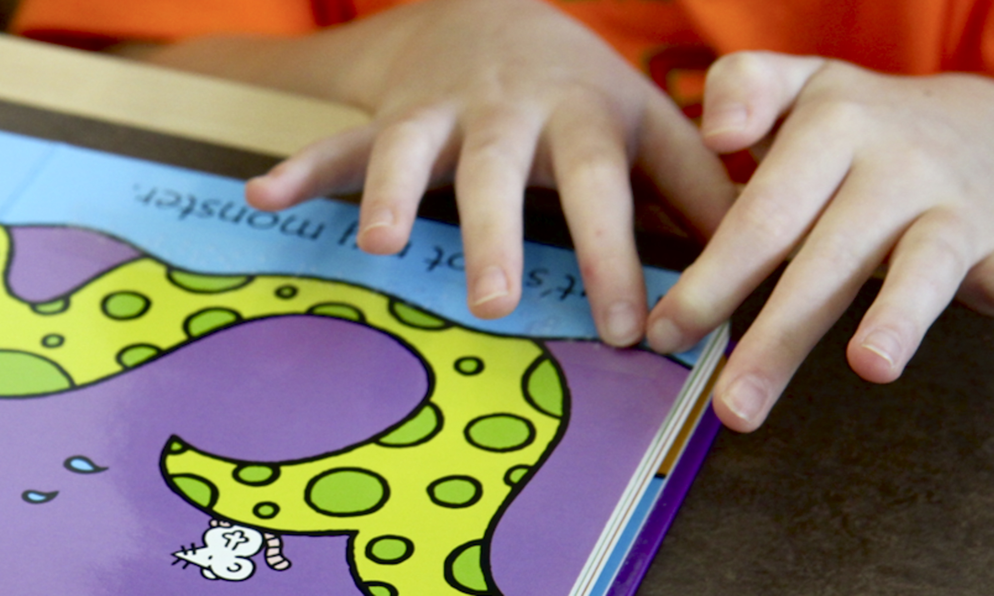 Child using braille to read a board book