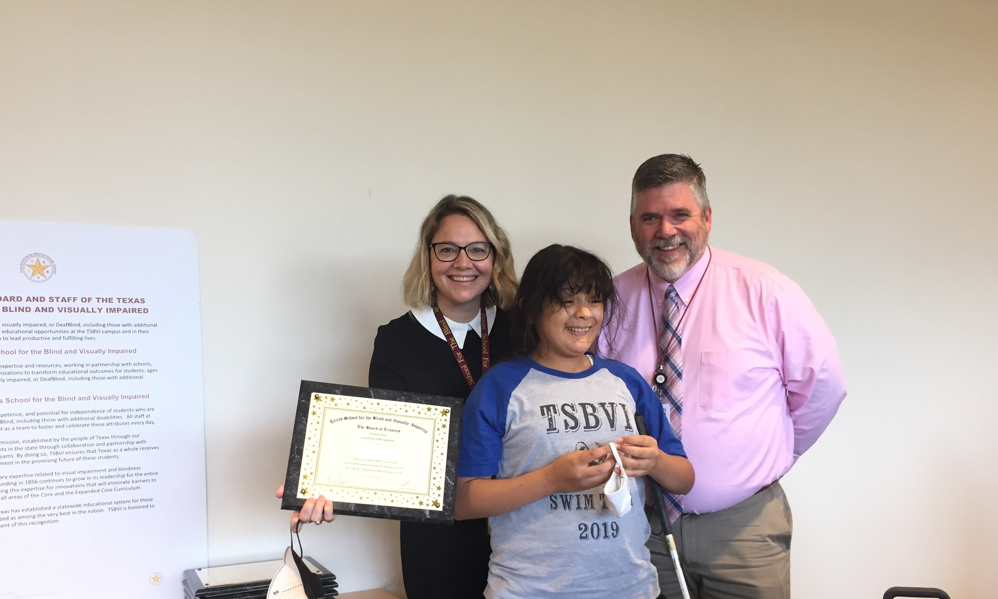 Staff at Student at TSBVI holding an award