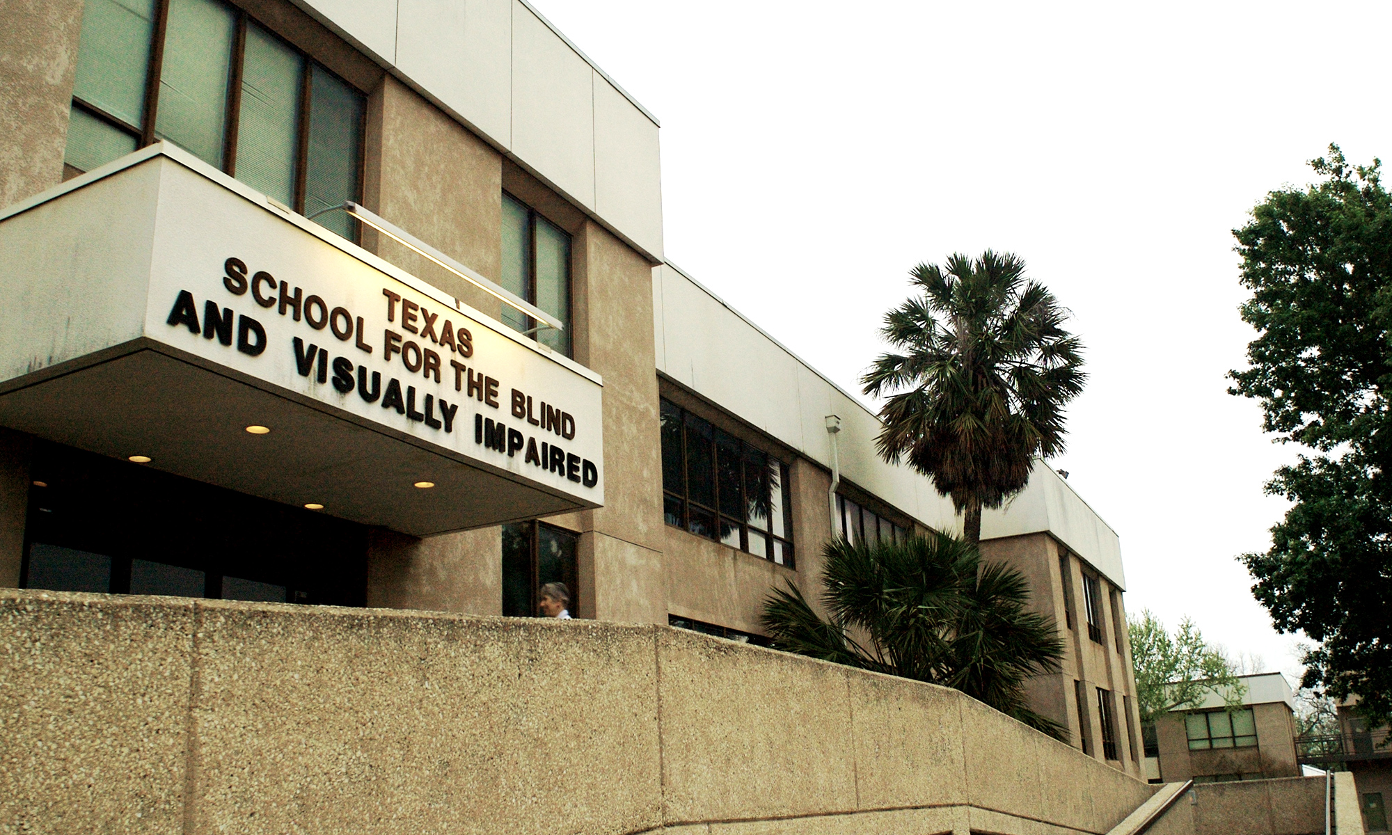 Previous main building on TSBVI Campus with palm trees