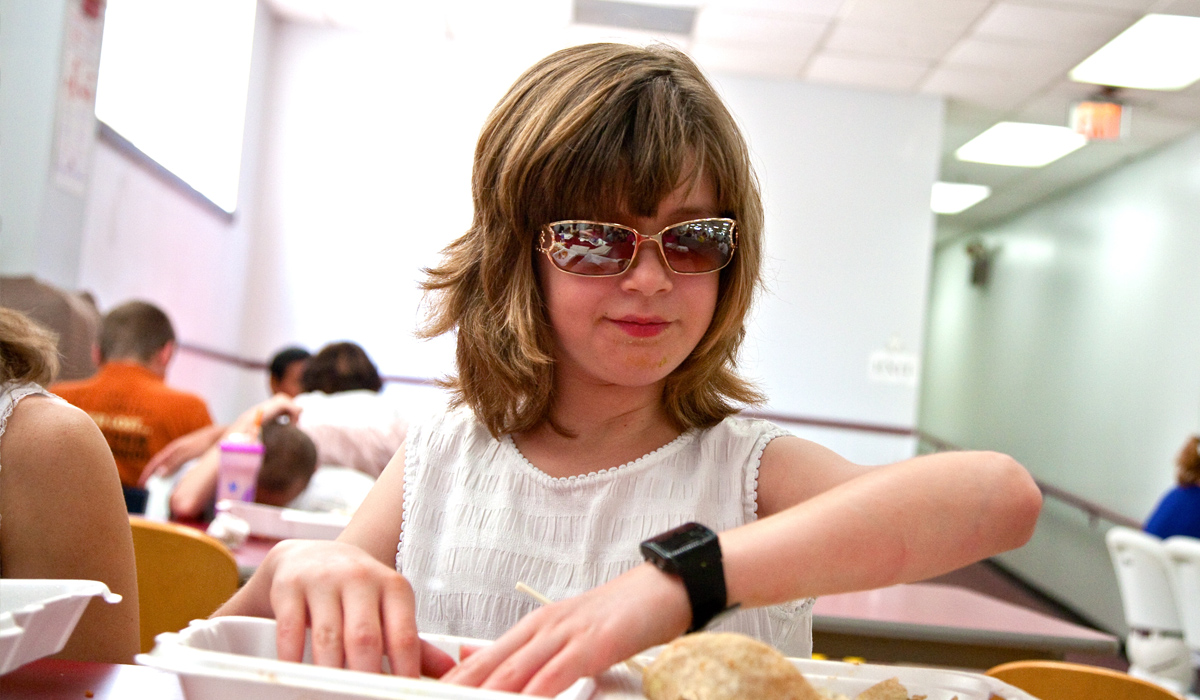 blind girl eating in cafeteria