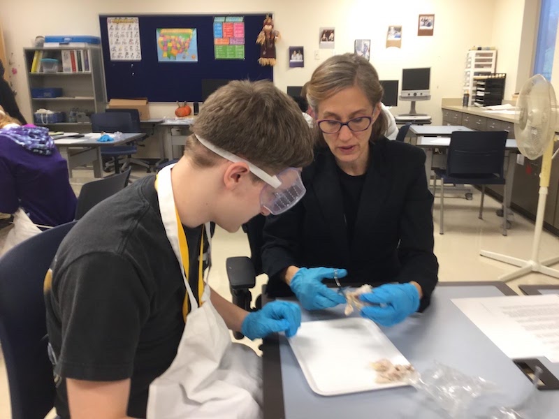 Teacher and student working on a science project