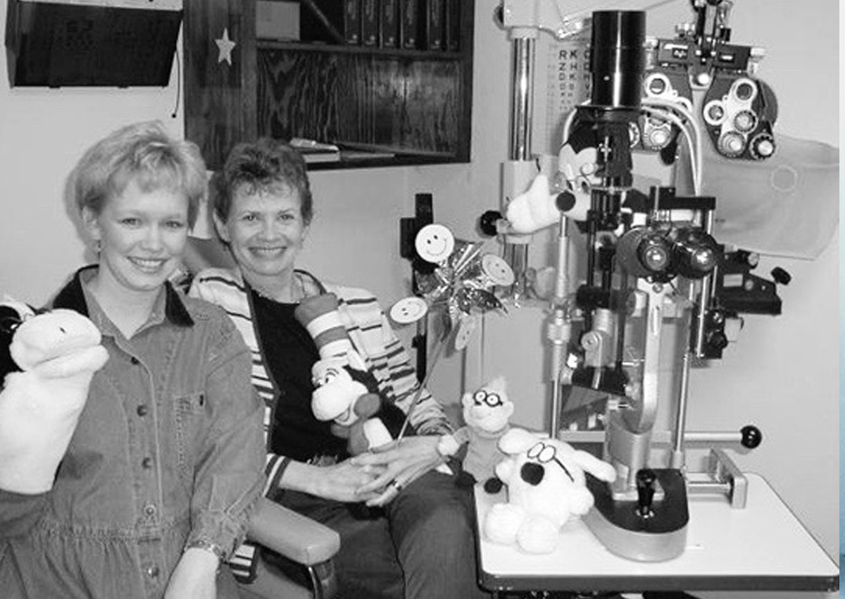 Nan Bulla and Dr. Laura Miller pose in the low vision clinic. 25 years ago!
