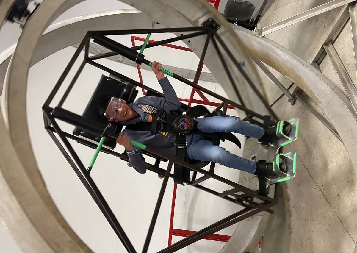 An adolescent uses an aerotrim Multi-Axis Trainer (MAT), a 3-axis gimbal large enough to contain a human being, used for cardiovascular training in pilots and astronauts.