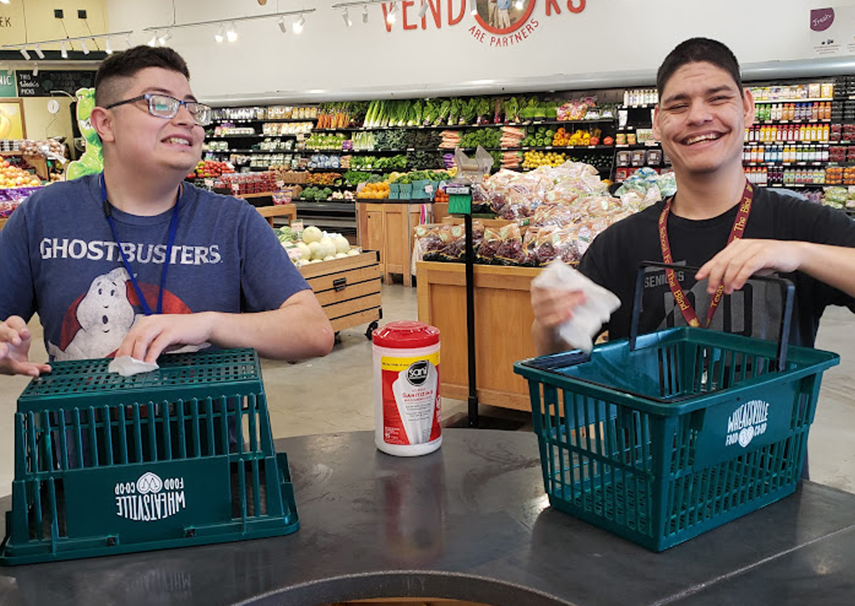 Two adolescents sanitize baskets at Wheatsville South Lamar Food Co-Op.