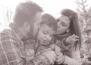 Two adults express their love for their child.