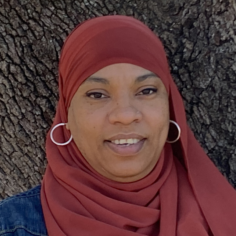 Nichelle smiling beneath a tree