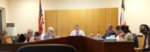 Board members at their desk conducting business