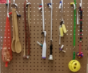 Photo of active learning position board. Peg board with various tools on it. 