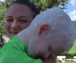 boy being held in a womans arms