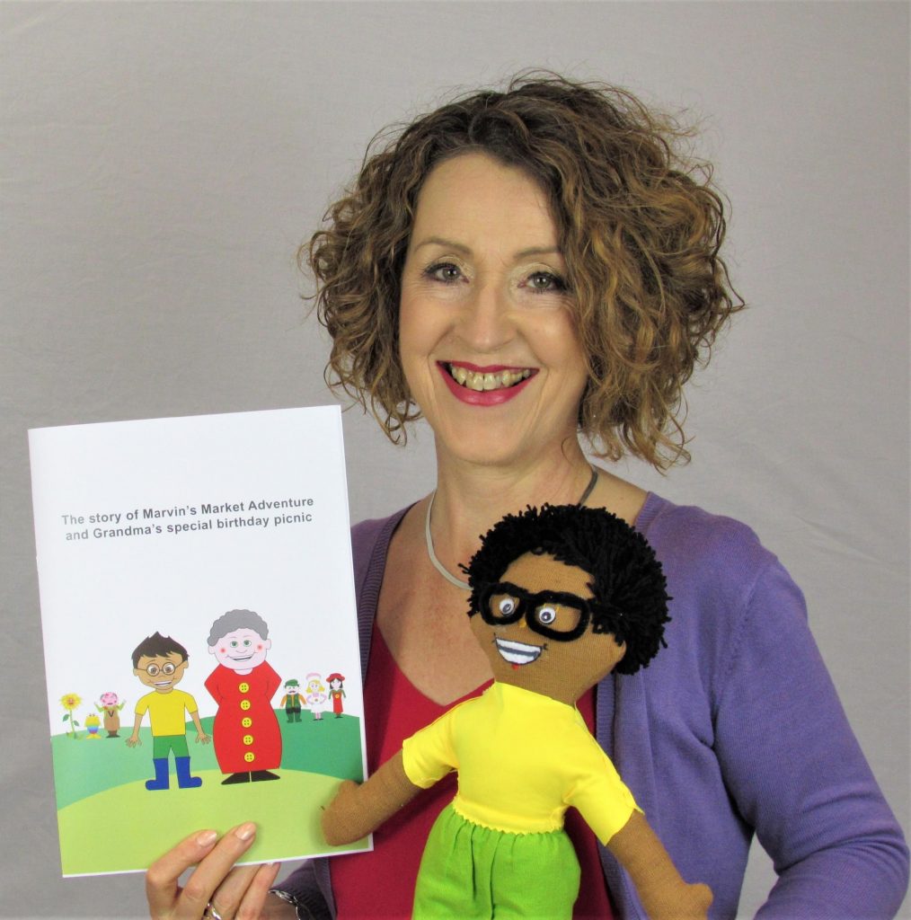 Gwyneth McCormack Holding the character Marvin along with her book, Marvin’s Market Adventure and Grandma’s Special Birthday Picnic
