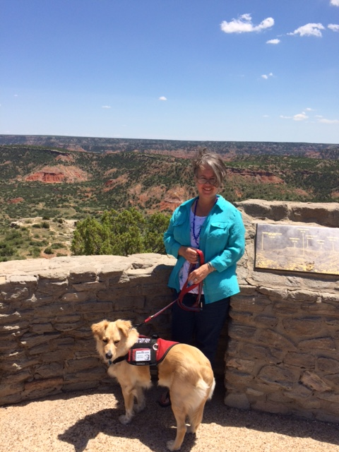 Rachel and her service dog, Ruby at Palo Duro Canyon. Ruby is wearing her red service dog vest