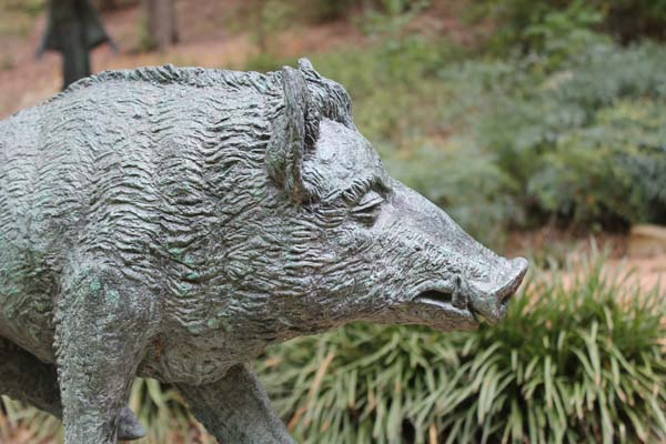 a photo of a sculpture of a bronze warthog