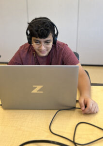 A student learns to use JAWS on a laptop.