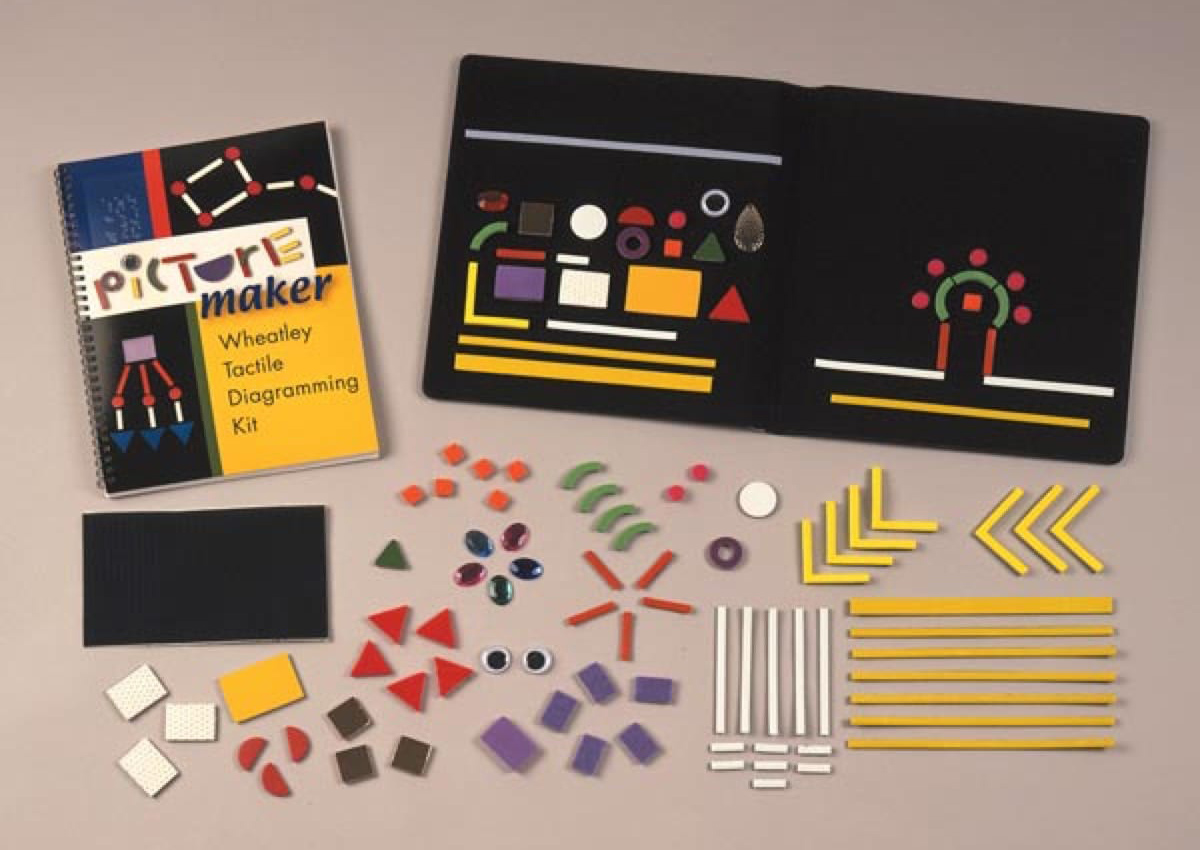 A black felt board with an array of colorful tactile shapes.