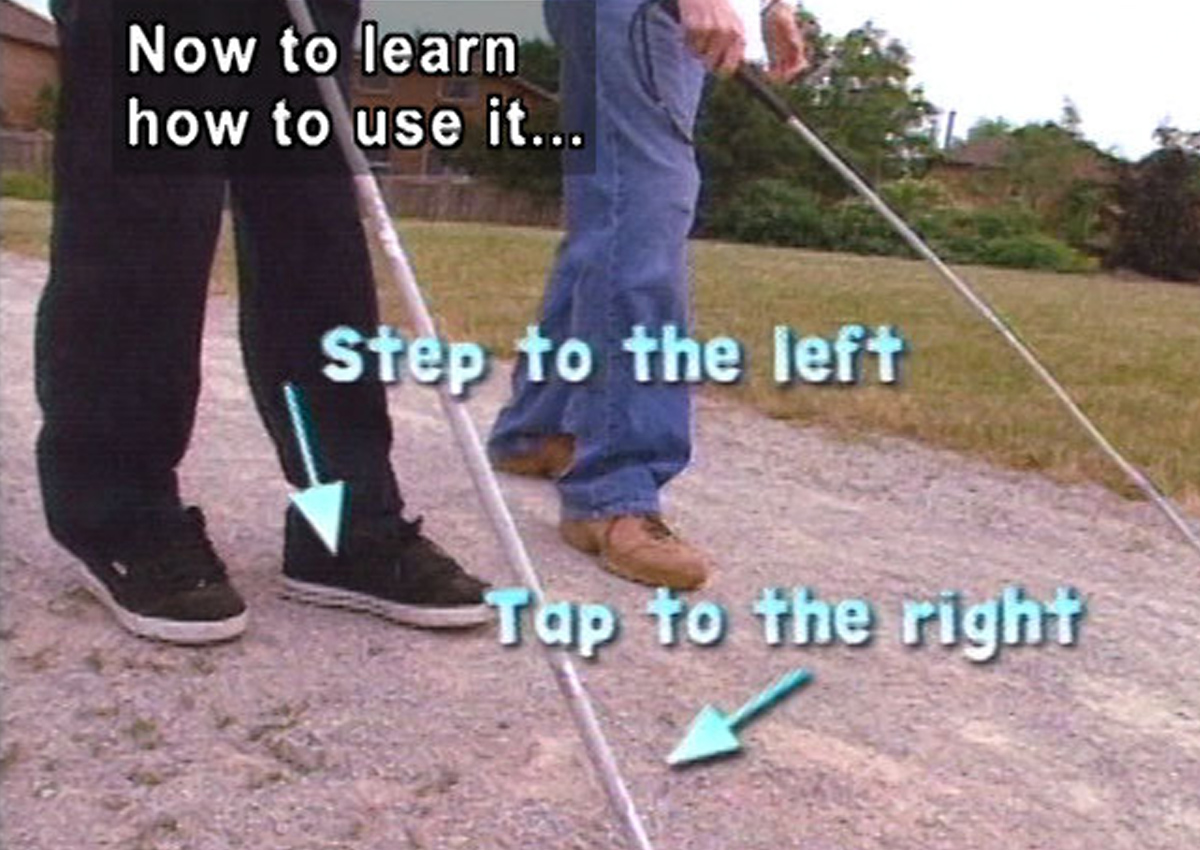 Two people are walking using long white canes. Text on screen reads: Now to learn how to use it…Step to the left; Tap to the right.